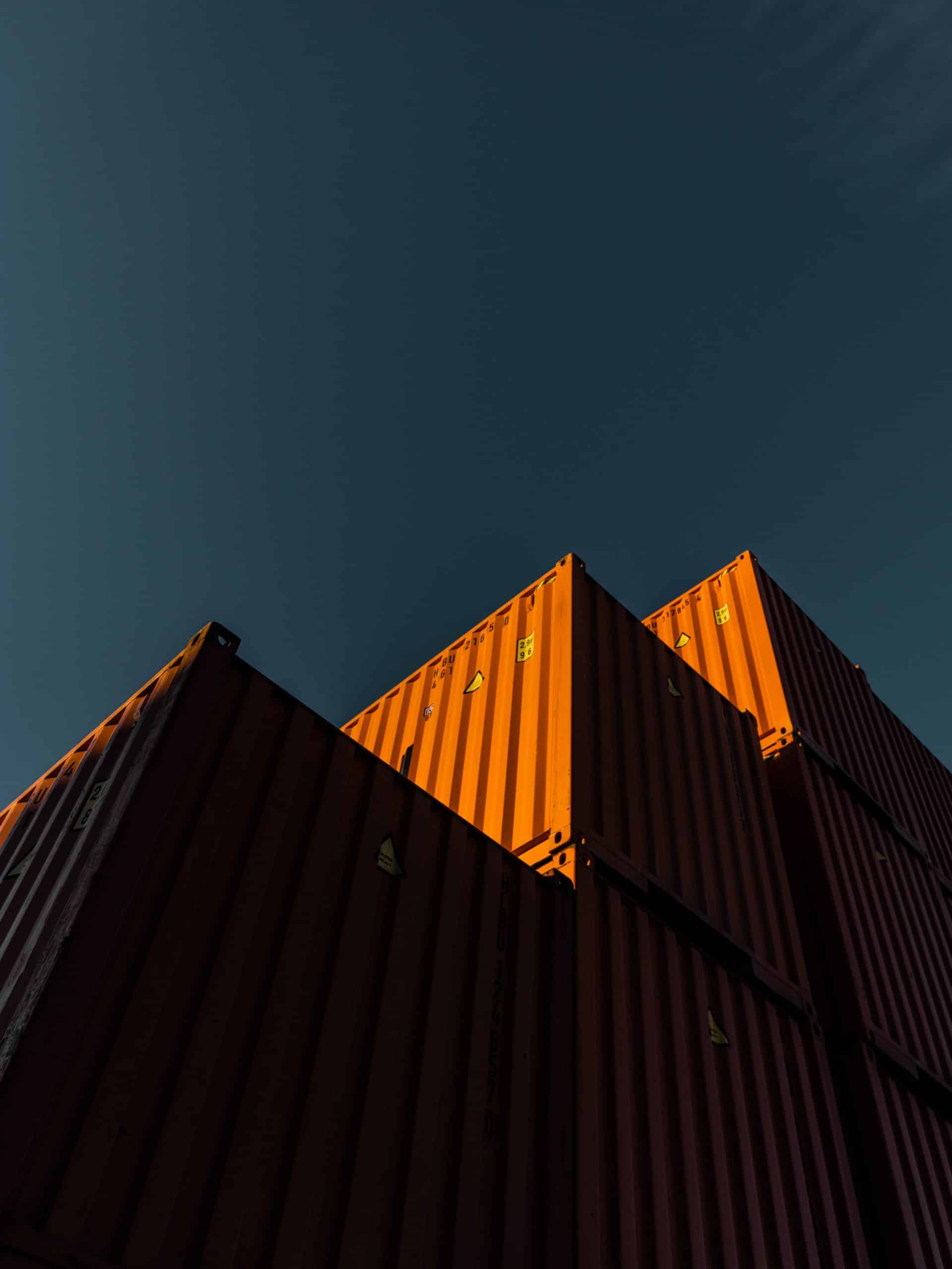 Orange containers stacked in the evening.
