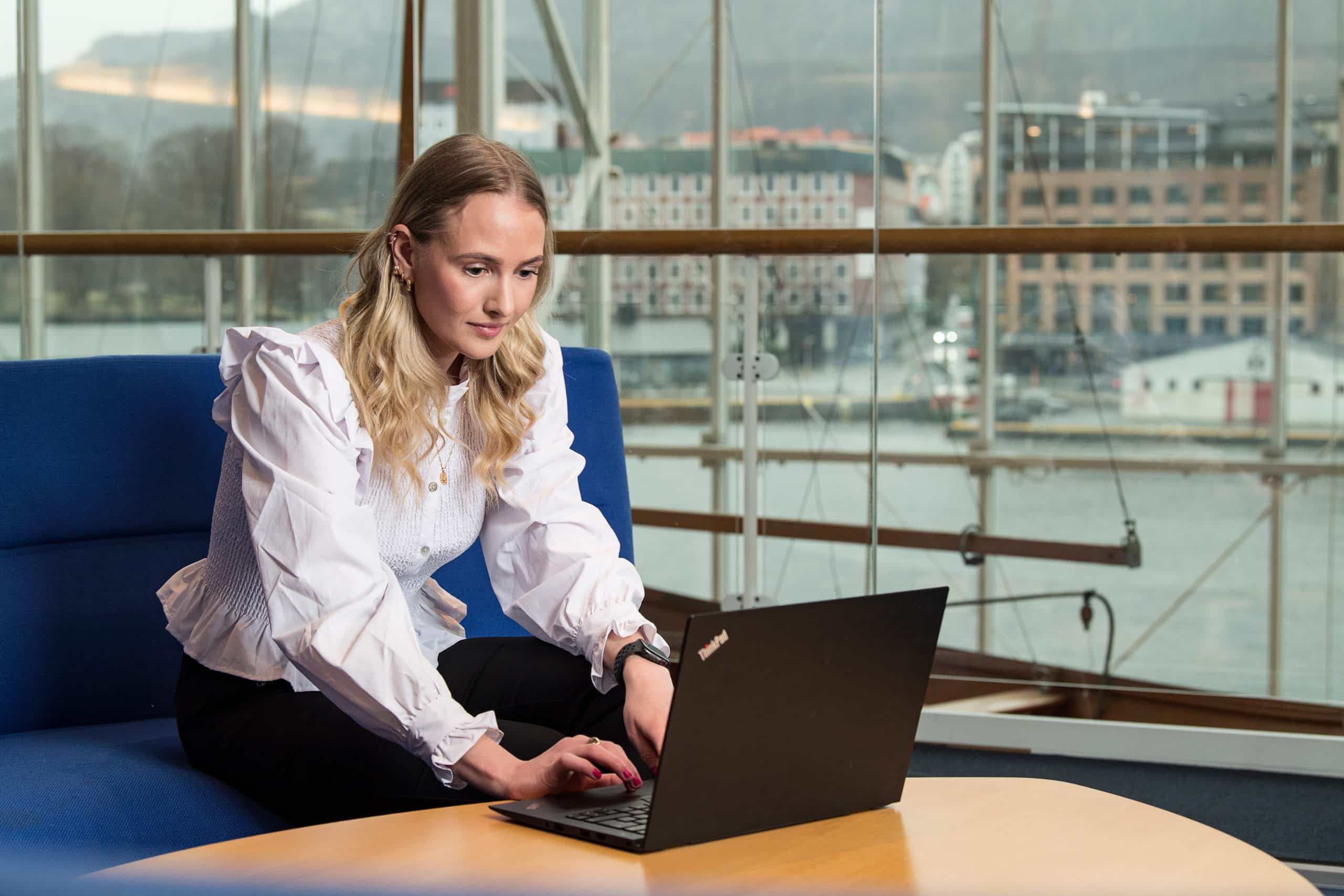 Grieg Shipbroker's talented shipbroker, Marit Eiken Fosse, works on a PC.