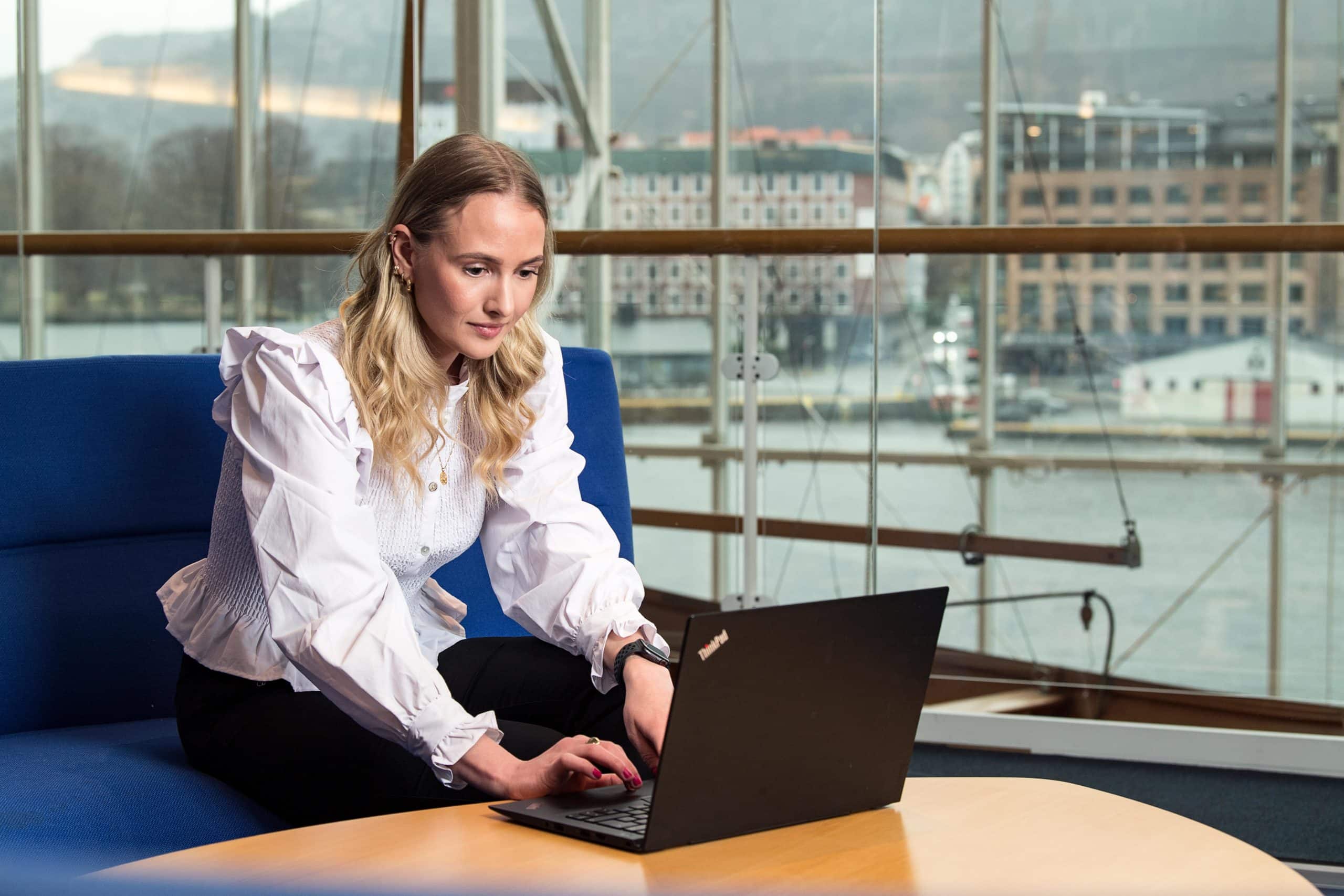 Grieg Shipbroker's talented shipbroker, Marit Eiken Fosse, works on a PC.
